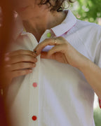 close up of woman wearing the west coast dress with colourful fabric-wrapped buttons