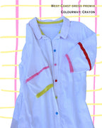 detail of white dress with colourful contrast colours in buttons and trim
