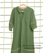 Close up of green dress with contrast green trim and buttons